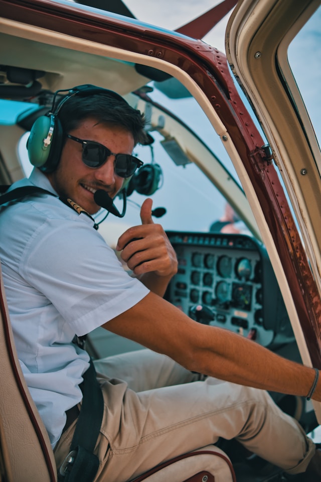 a-man-sitting-in-the-cockpit-of-a-plane-giving-a-thumbs-up